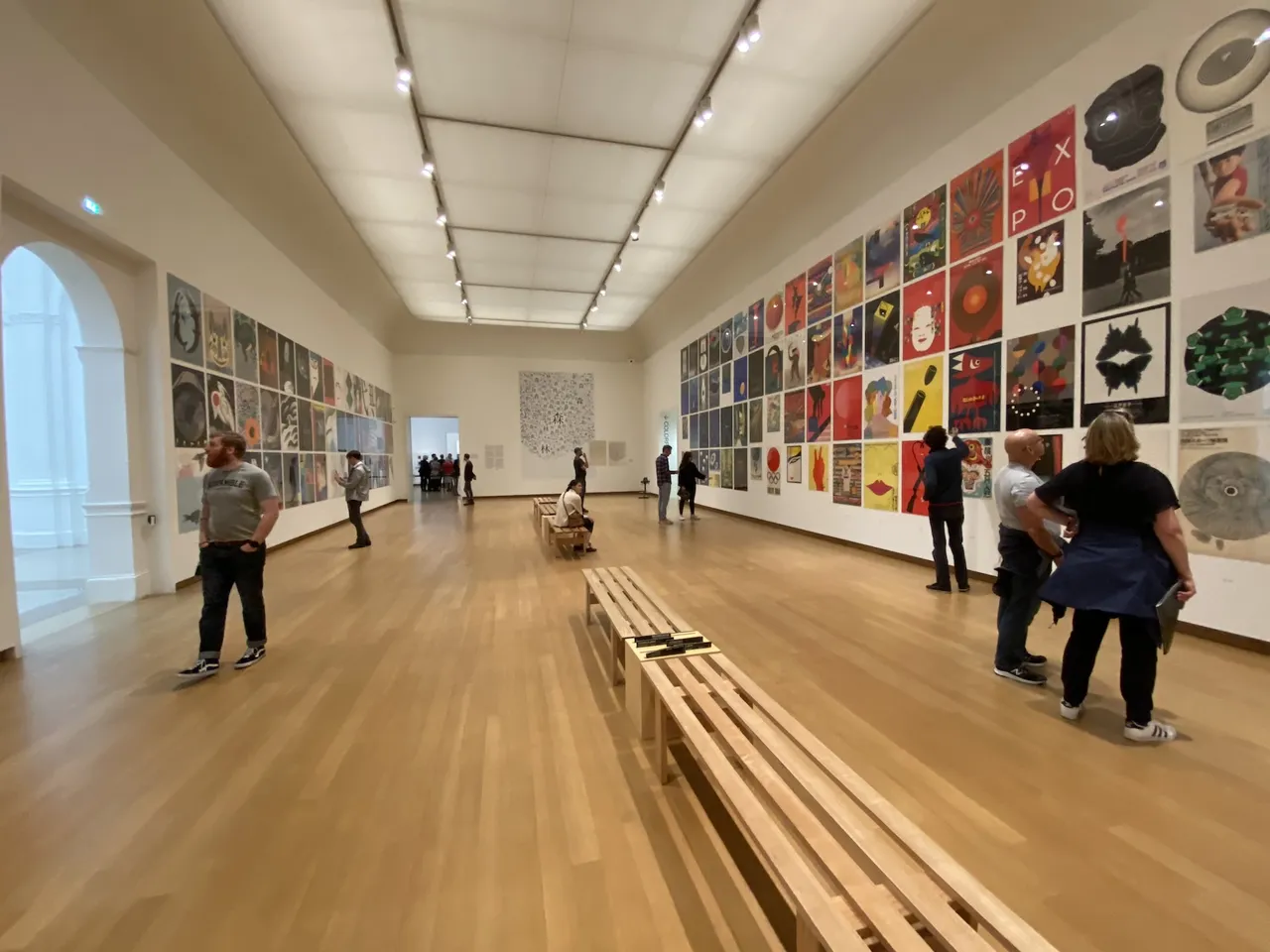 A bright gallery with walls adorned with modern art.