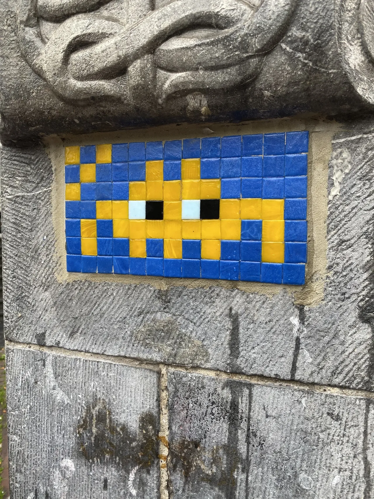 A mosaic on a wall in Amsterdam. It depicts a Space Invader.